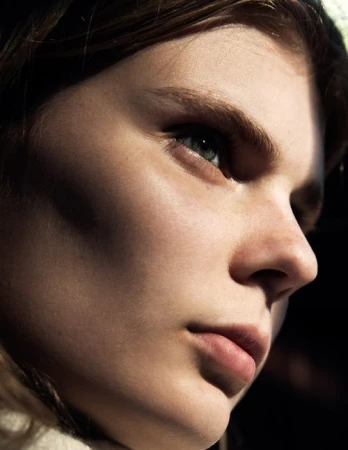 Close-up profile portrait of a woman with natural light highlighting her face, photographed by Todd Barry in Sydney.