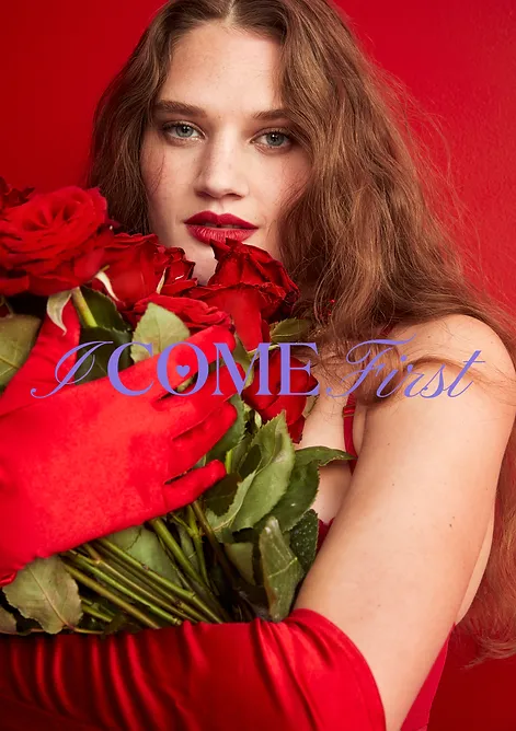 Portrait of a long-haired woman with red lipstick, holding a bouquet of red roses, wearing a red gown and gloves, against a red backdrop.