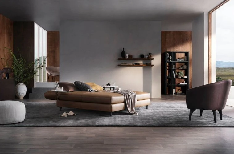 Interior design showcasing a contemporary living room with a brown leather sofa, accent chair, open shelving, and view to the outside.