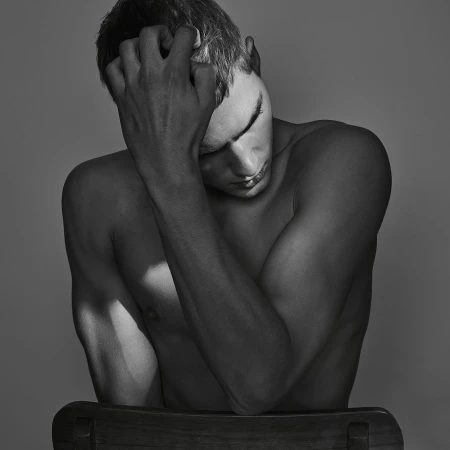 Monochrome portrait of a shirtless man running a hand through his hair with eyes closed, by photographer Jez Smith
