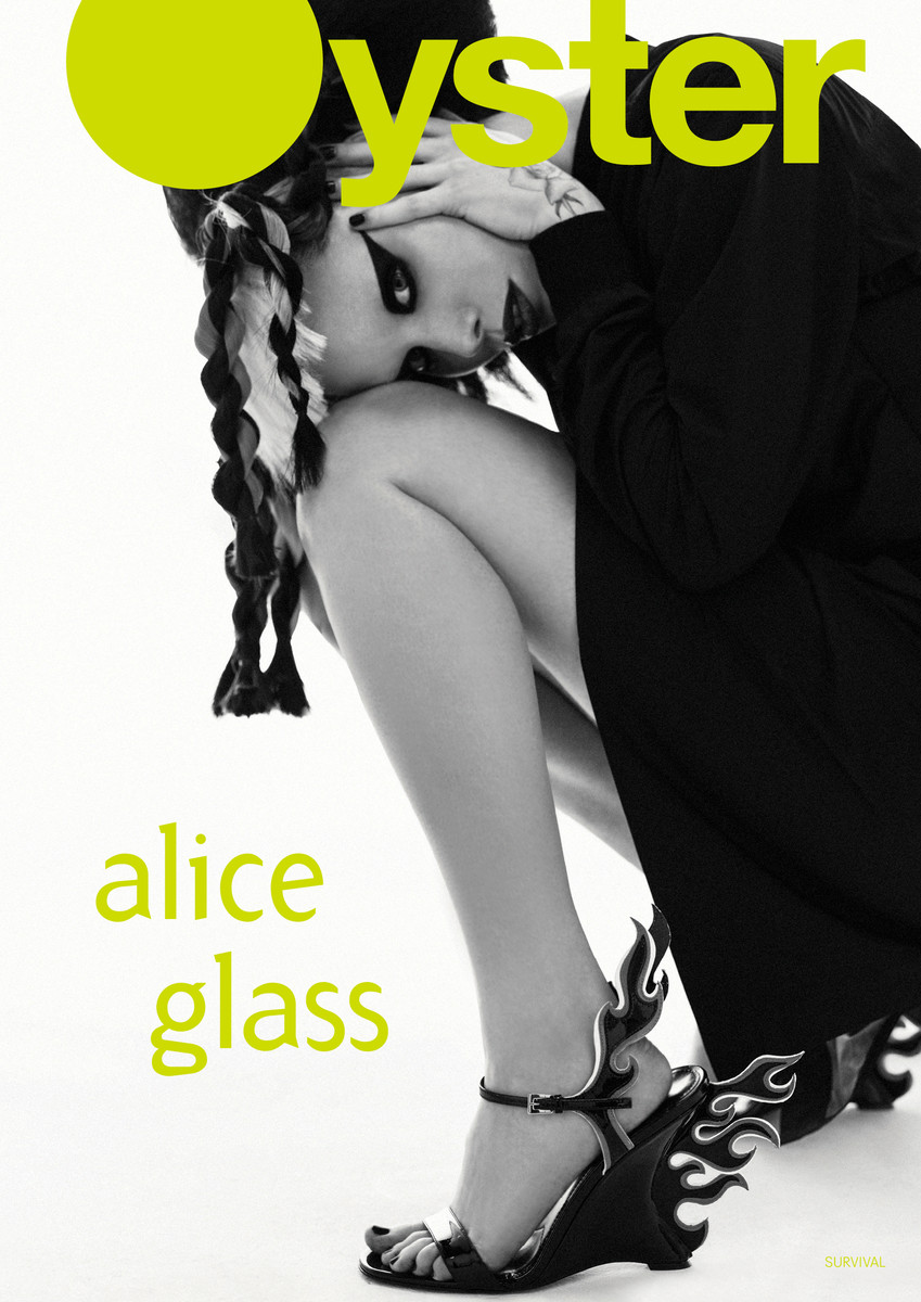 Oyster magazine cover featuring a stylishly dressed woman with braids, unique shoes, and dramatic makeup against a white backdrop.