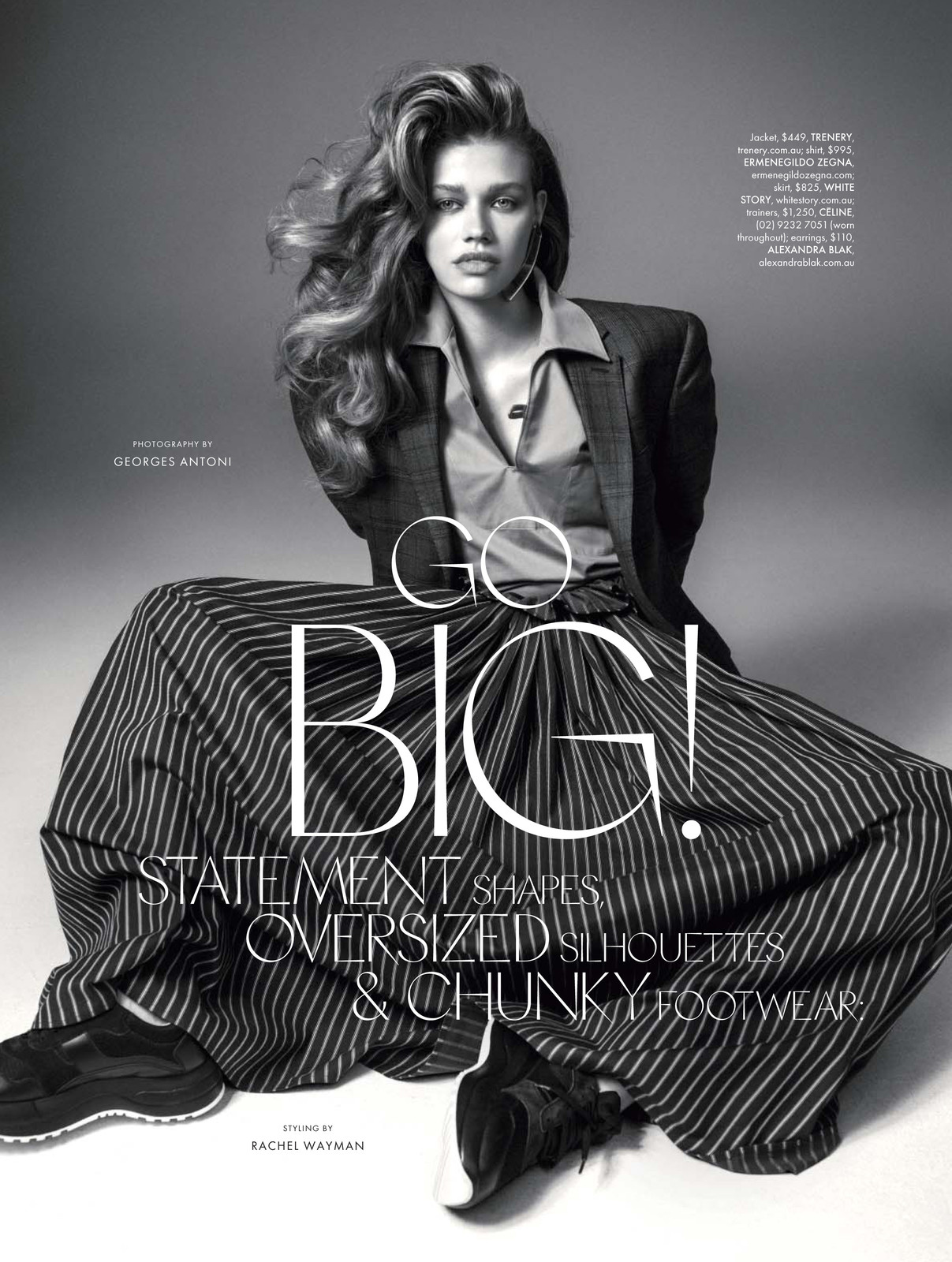 Editorial fashion shot featuring a stylish woman in a blazer and striped skirt, posing in a studio with bold text overlay.