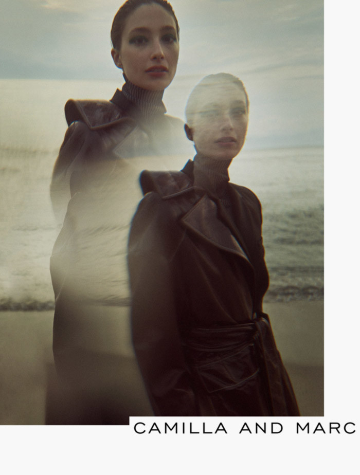 Fashion editorial shot of a model in a brown leather coat on a beach, featuring a double exposure effect and Camilla and Marc text.
