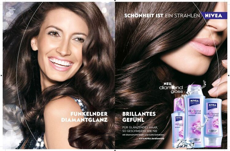 Beauty ad with a smiling woman with long brown hair and hair product bottles. The Nivea ad promotes the diamond gloss line for shiny hair.
