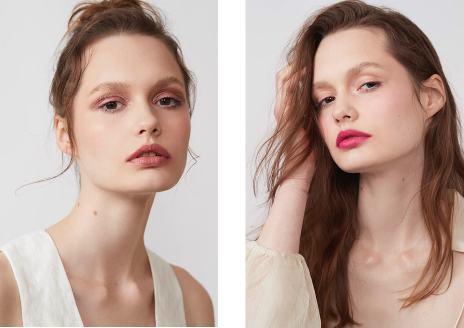 Beauty shot of two young adult women with light skin and neutral expression wearing fashionable make-up in front of a white background.