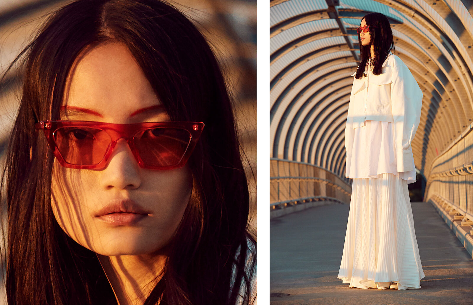 Fashionable Asian woman with long dark hair in red sunglasses, wearing a white jacket and skirt, posing on a metal bridge.