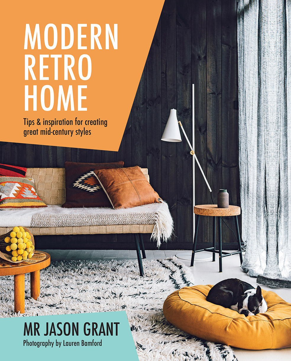 Living room interior showcasing a modern retro home design with a daybed, cushions, and a dog resting in a yellow pet bed on a patterned rug.