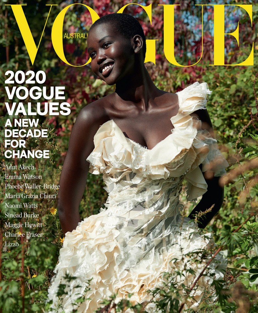 Vogue Australia cover featuring a smiling Black woman in an off-white dress, set against a background of foliage and plants.