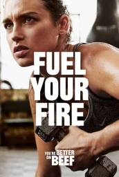 Sweaty female athlete holding a dumbbell in a gym interior with large overlaid white text reading FUEL YOUR FIRE