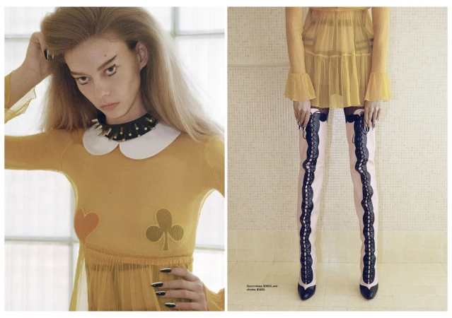 Blonde fashion model in a sheer yellow dress and black choker poses against a window and cream-colored tile in a studio shot.