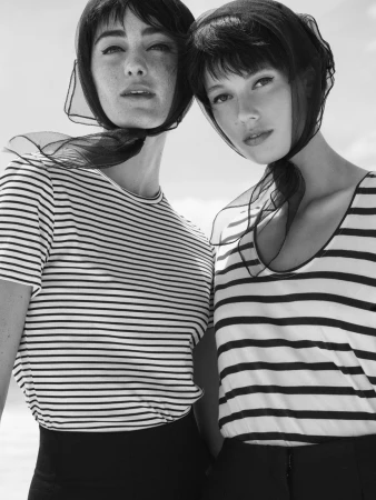 Two women wearing striped shirts and sheer headscarves in a black and white portrait by stylist Nicola Burford in Sydney