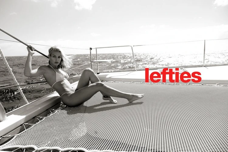 A woman in a bikini poses on a yacht, enjoying the sun and sea in a monochrome image with red text overlay, creating a fashion-forward aesthetic.