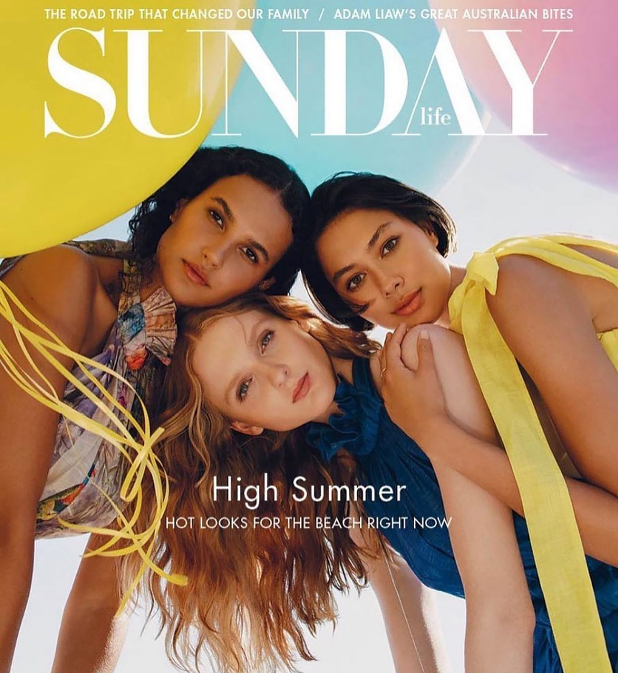 Three women pose for a magazine cover featuring 'Sunday Life' and 'High Summer' with a yellow balloon in the background.