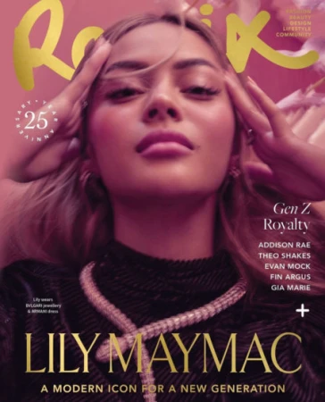 Close-up magazine cover portrait of a young woman with long hair wearing a black textured top and silver necklace against a pink backdrop.