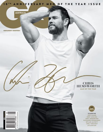 Magazine cover featuring Chris Hemsworth in a white t-shirt, black pants, and a tan signature, promoting GQ Australia's Men of the Year issue.
