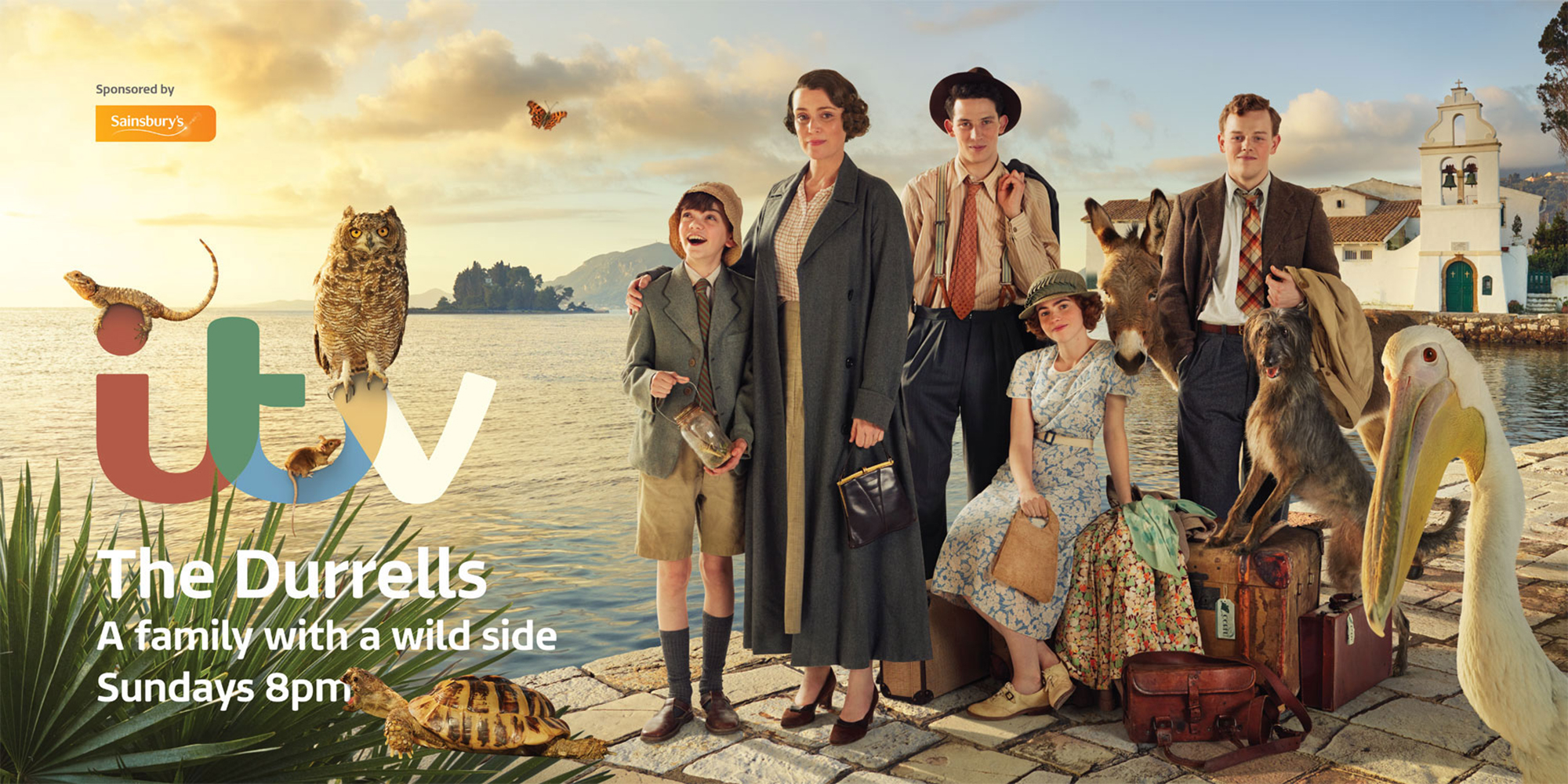 Family posing with animals by the sea. Group of people standing with a donkey, dog, and pelican on a pier by a Mediterranean Sea.
