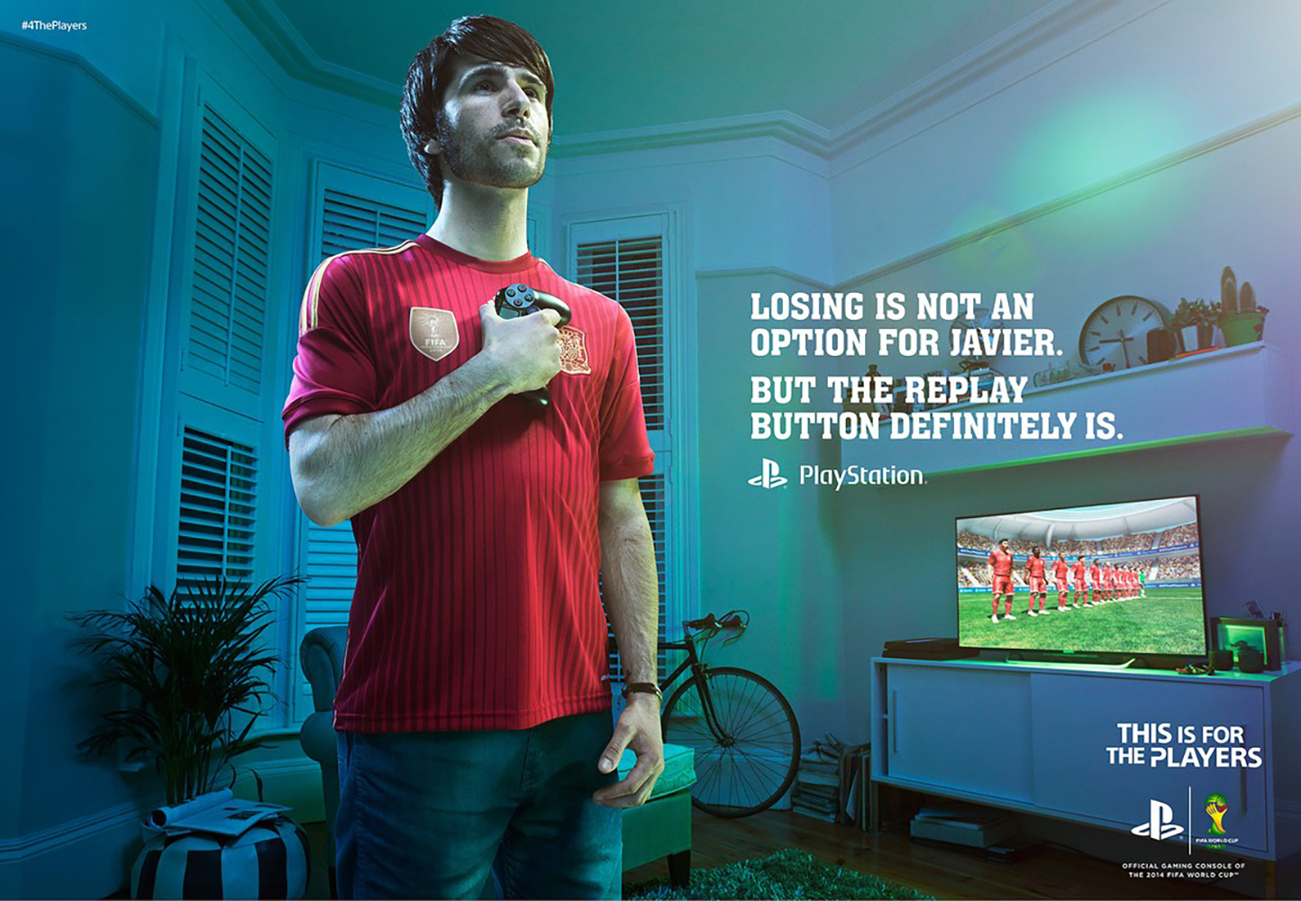 Man in soccer jersey holds game controller in living room. TV shows soccer match. Ad for PlayStation, This is for the players.
