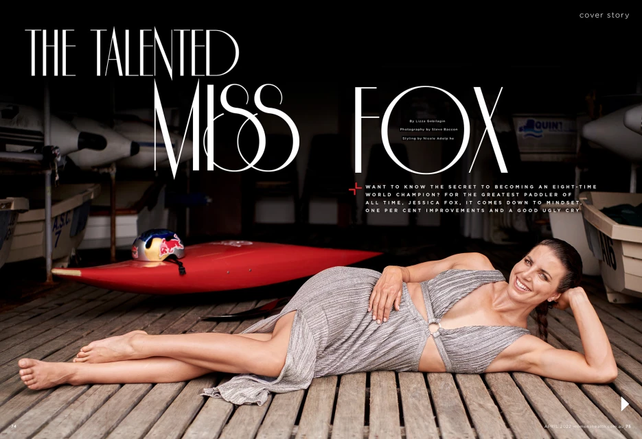 Jessica Fox photographed lying on a wooden surface near a red kayak, advertising a cover story, with a dark blurred background.