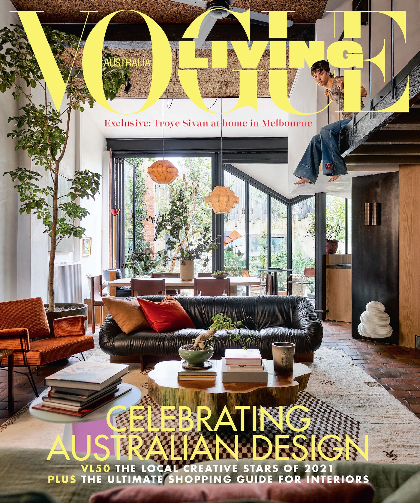 Vogue Living Australia magazine cover featuring a living room interior with a person on a staircase and the magazine's title.