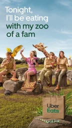 Group of four people enjoying food outdoors with exotic animals and a parrot for an Uber Eats advertising campaign.