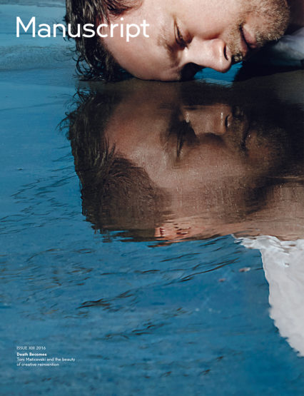 Magazine cover featuring a man's face reflected in water, with the title 'Manuscript' visible in the upper left corner.
