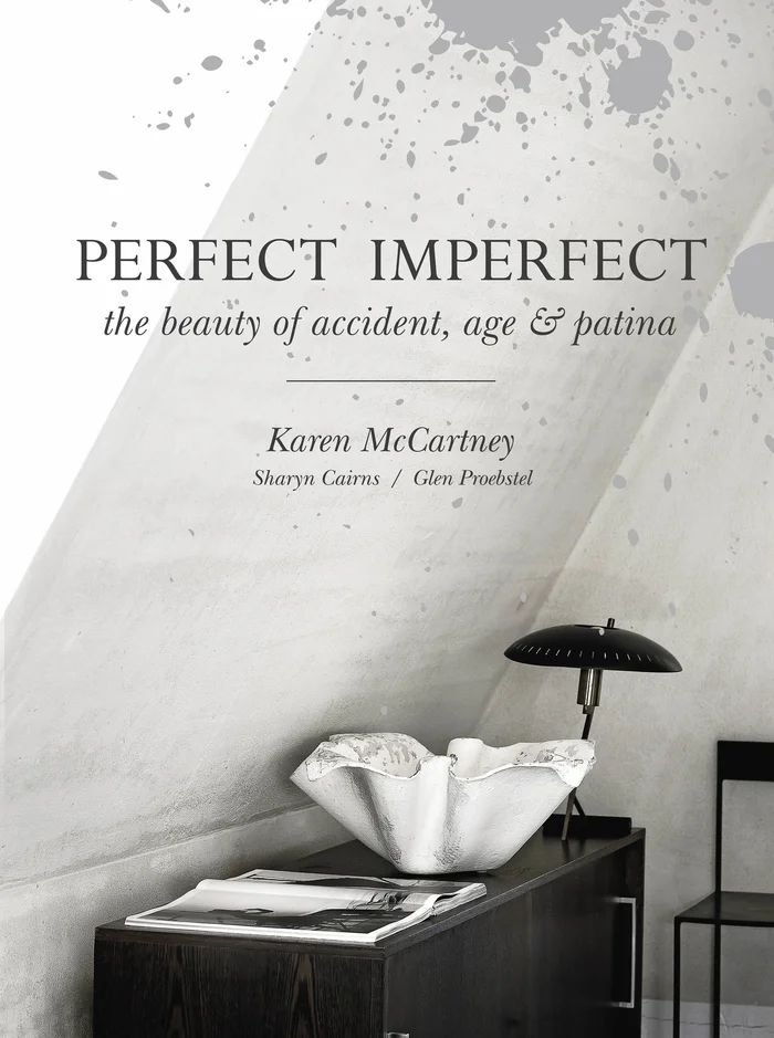 Book cover for Perfect Imperfect featuring a white decorative ceramic bowl and dark lamp on a wooden cabinet.