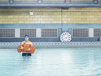 Swimmer wearing blue cap and goggles holding an orange duffel bag in a tiled indoor swimming pool by photographer Zachary Scott