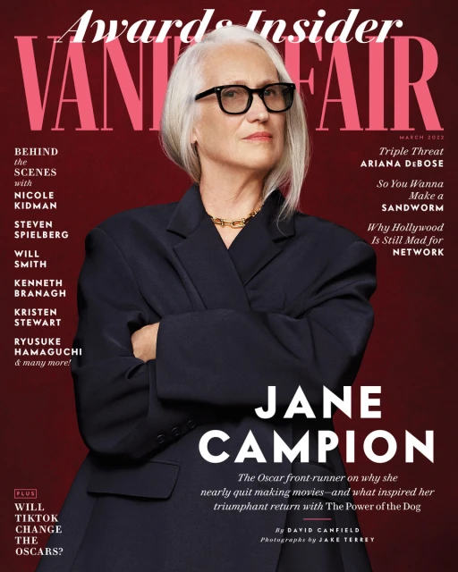 Vanity Fair magazine cover featuring Jane Campion in a medium shot, wearing a navy blazer and glasses, against a solid red background.