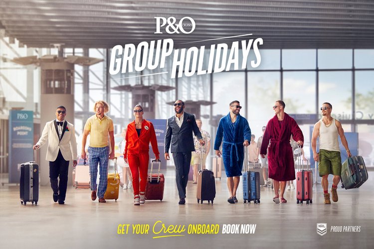 Group of seven adults pulling luggage in airport terminal; two adult men in bathrobes, one man in tuxedo, travel advertisement.