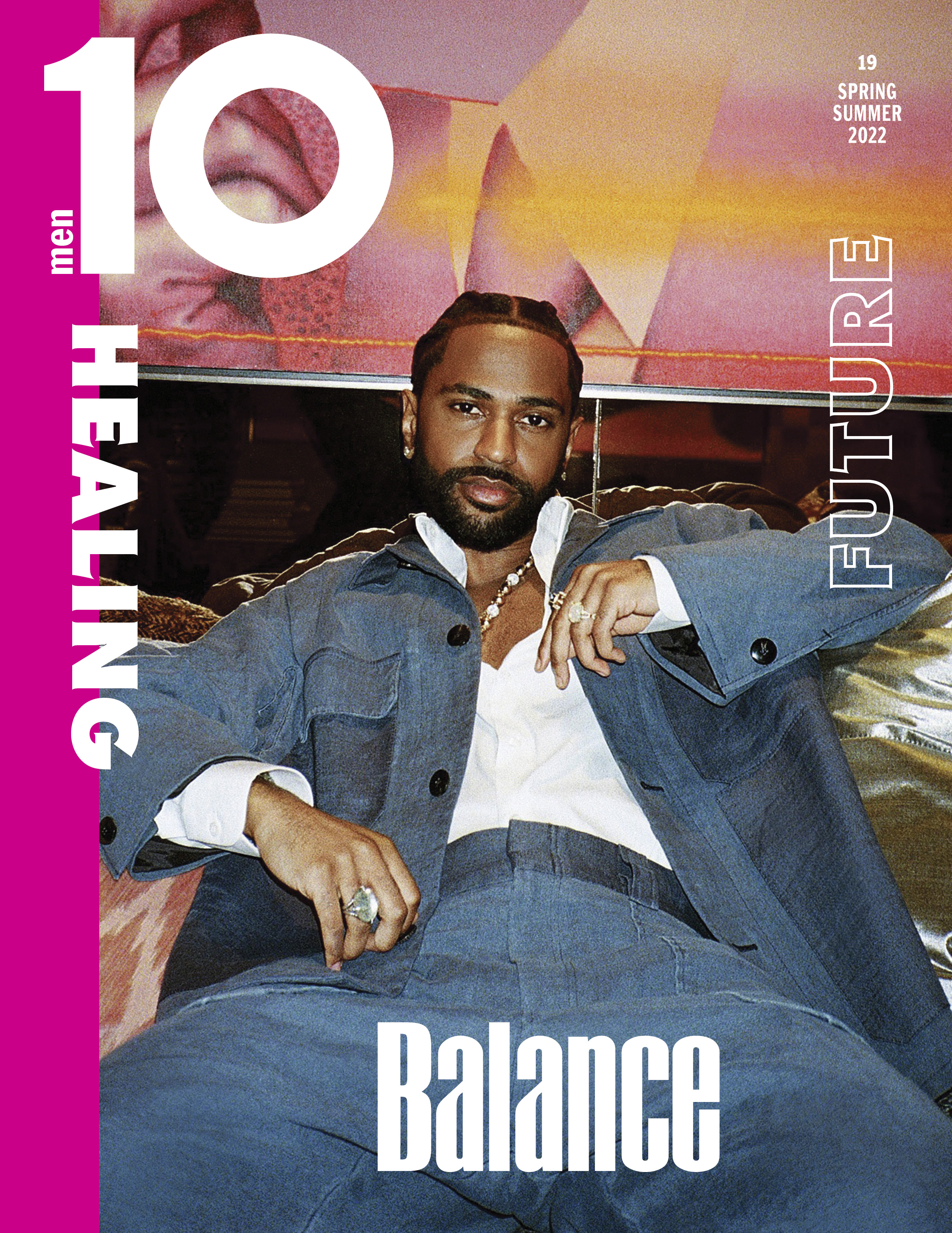 Magazine cover featuring a man with a short beard wearing a denim suit, a white shirt, and pearl necklace, against an abstract background.