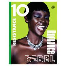 Magazine cover featuring a close-up of a smiling African American woman with dramatic eye makeup, wearing a jeweled necklace against a lime green background.