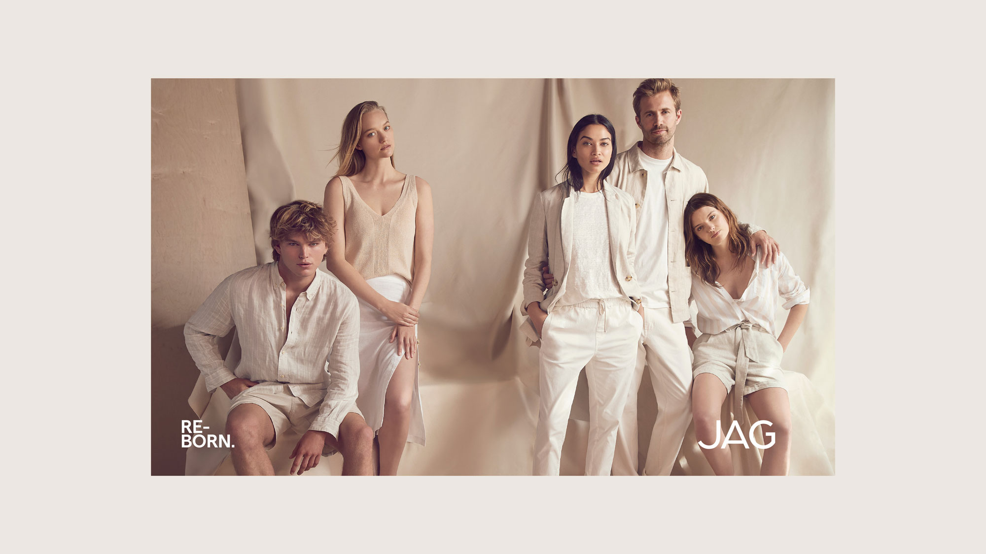 Group of five fashion models wearing neutral linen clothing in a studio setting, showcasing light and airy summer styles for a brand campaign.