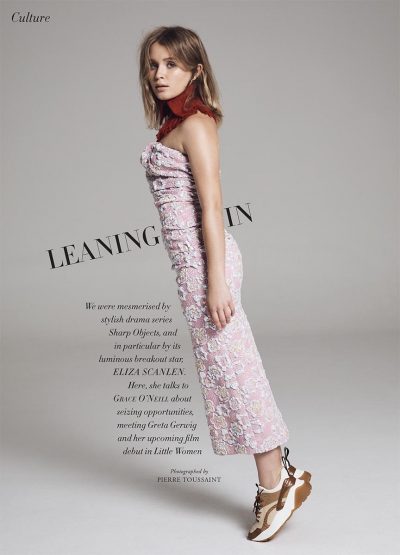 Eliza Scanlen poses in a pink floral dress with sneakers against a gray background, promoting film 'Little Women'. Editorial fashion photography.
