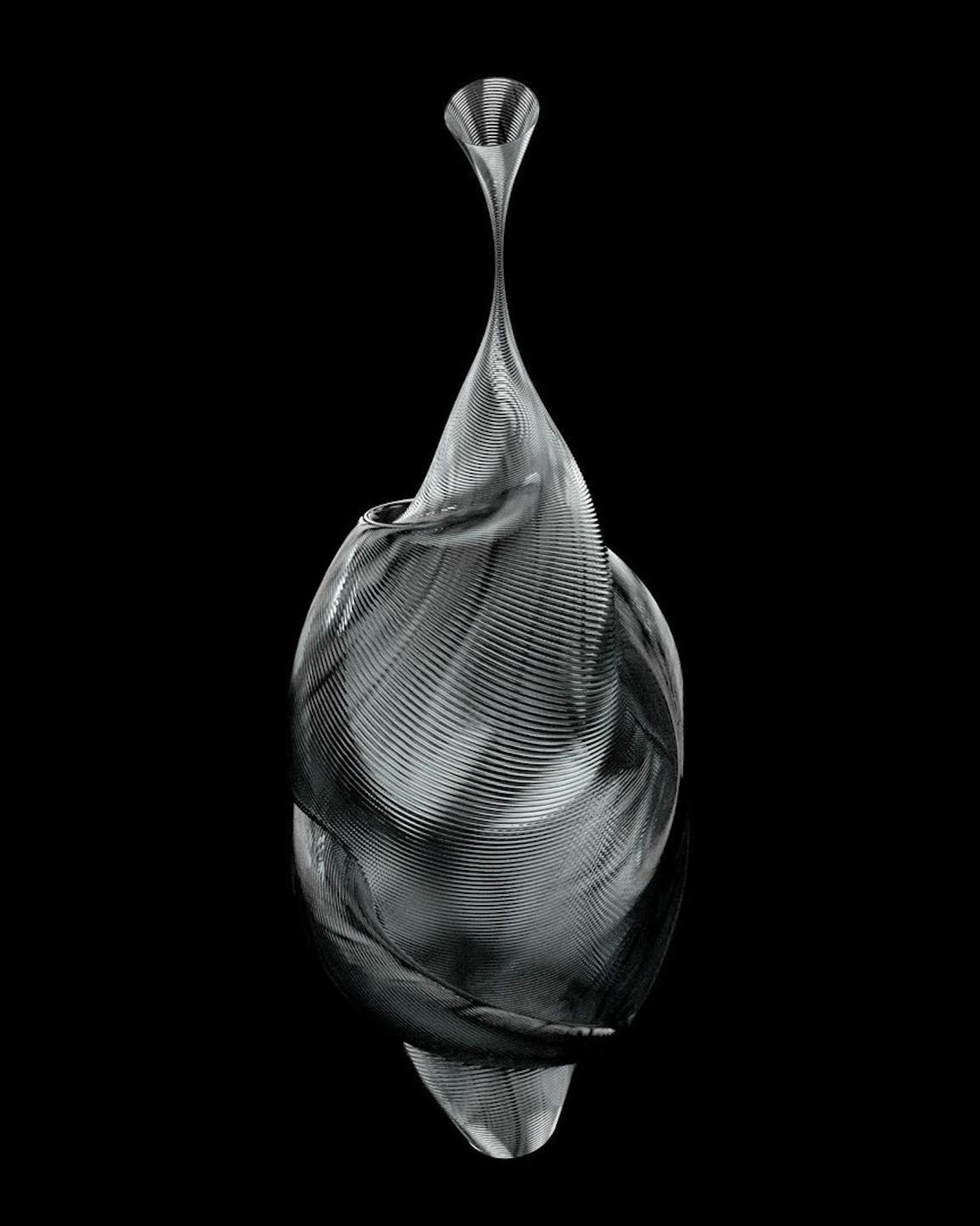 Abstract metallic sculpture with swirling linear pattern against a black backdrop, creating a modern and artistic visual composition.