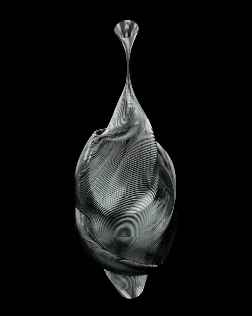 Abstract metallic sculpture with swirling linear pattern against a black backdrop, creating a modern and artistic visual composition.