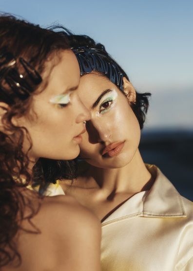 Two women with creative pastel eyeshadow and metallic hair clips in Sydney by make-up artist Sarah Tammer