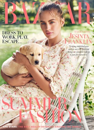 Magazine cover featuring a young adult woman holding a light yellow Labrador puppy, soft lighting, outdoor setting, promoting summer fashion.