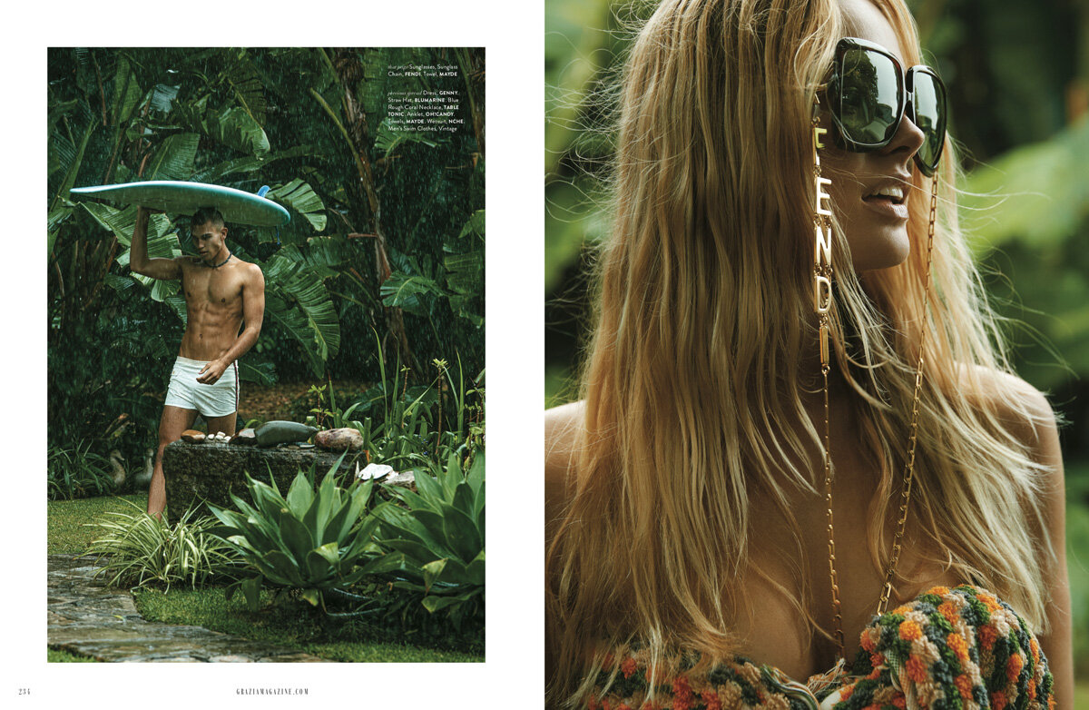 Editorial shot features a man under a surfboard in a tropical setting and a woman with sunglasses and a Fendi chain, lush greenery.