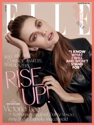 Close-up portrait of Victoria Lee wearing a black leather jacket against a neutral studio background for a magazine cover.
