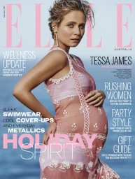Pregnant woman in a pink lace dress posing outdoors against an ocean background for an Elle Australia magazine cover.
