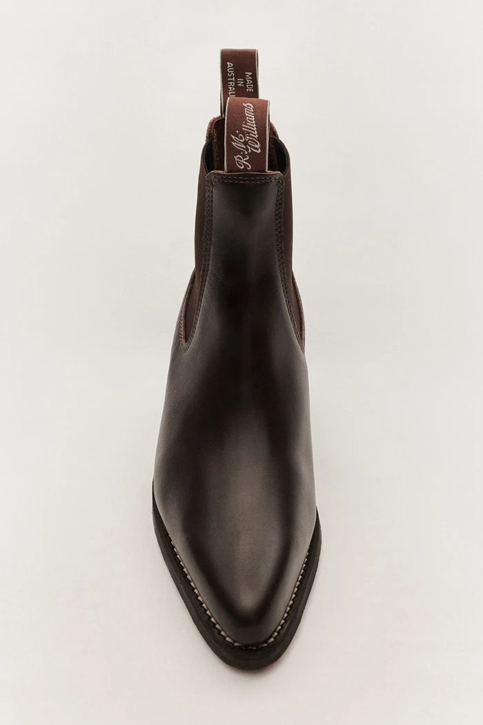 Dark brown leather chelsea boot viewed from the front against a clean white background