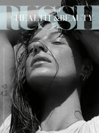 Magazine cover featuring a woman with wet hair, closed eyes, and a serene expression, bathed in natural light, with 'RUSH HEALTH & BEAUTY' text overlay.