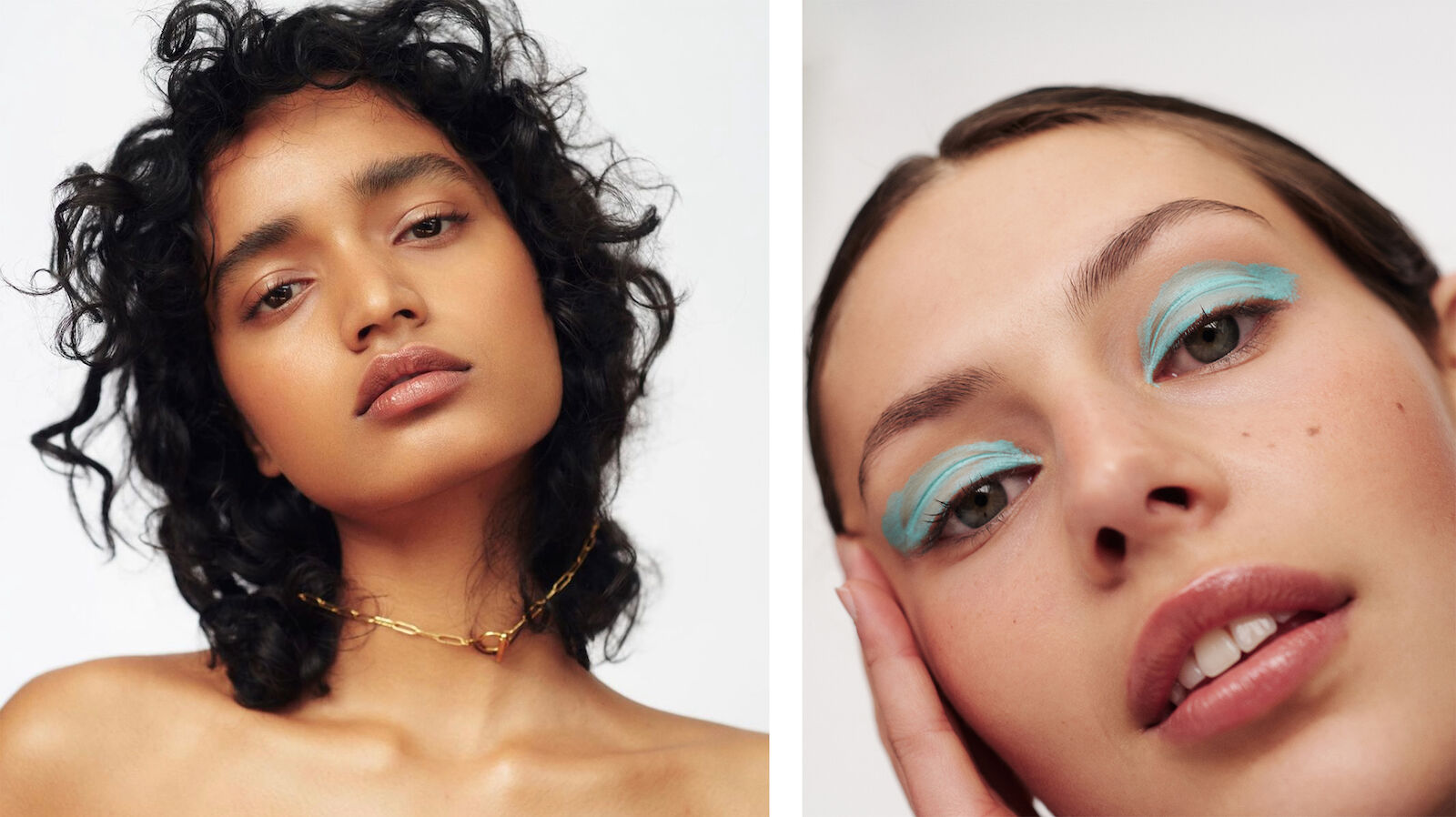 Two women with creative makeup; one woman with dark curly hair and gold necklace; one woman with light skin and blue eyeshadow.