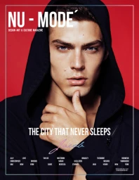 Close-up portrait of a man in a black hoodie posing against a solid red background with magazine cover typography