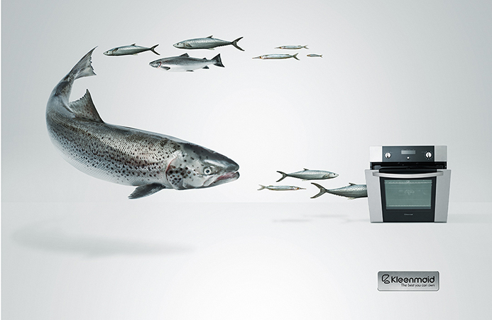 Stylized image of a school of fish swimming toward an oven, set against a light background, promoting Kleenmaid appliances.