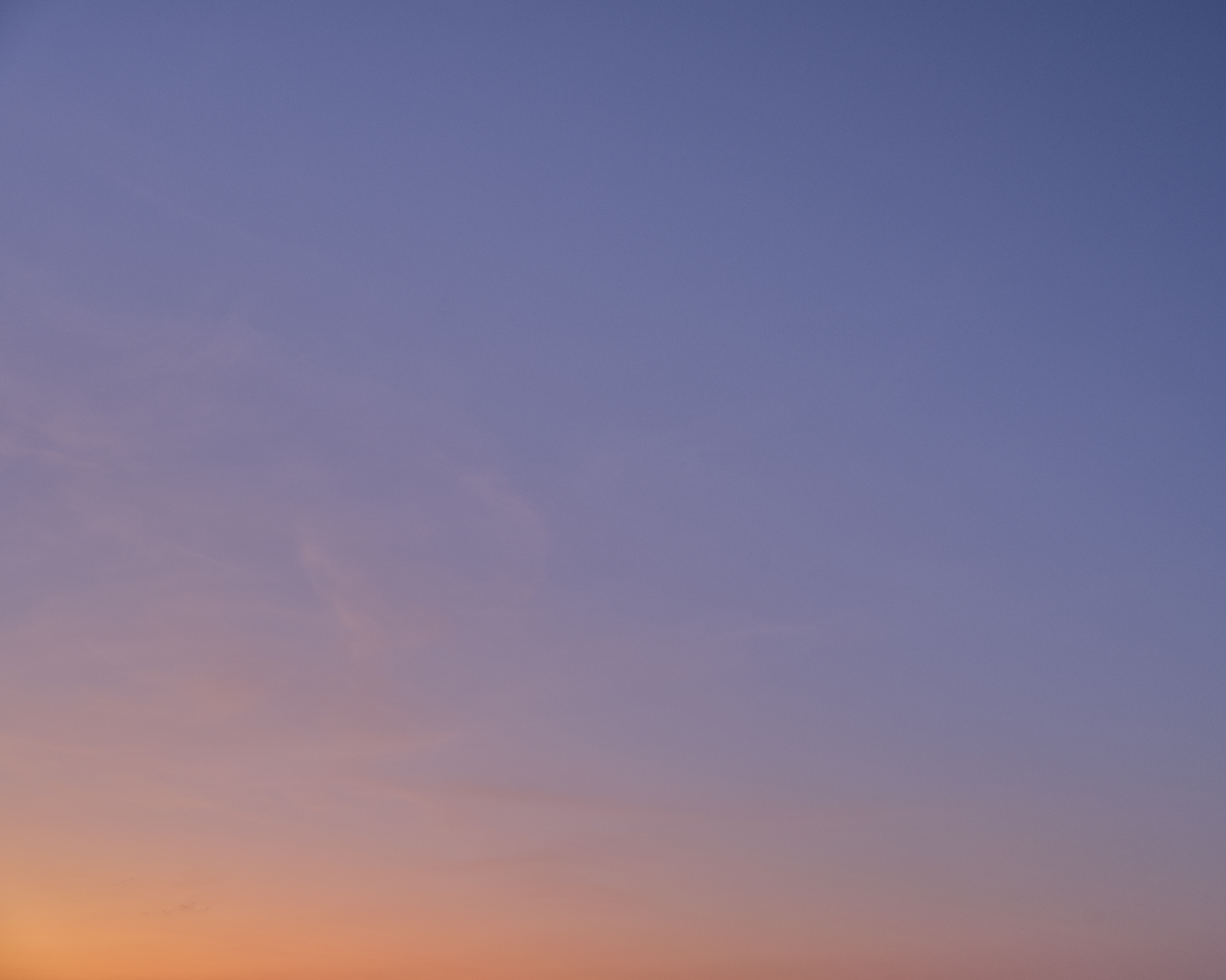 Gradient sky with soft pastel hues of blue, purple, and orange blending seamlessly, creating a serene and tranquil atmosphere.