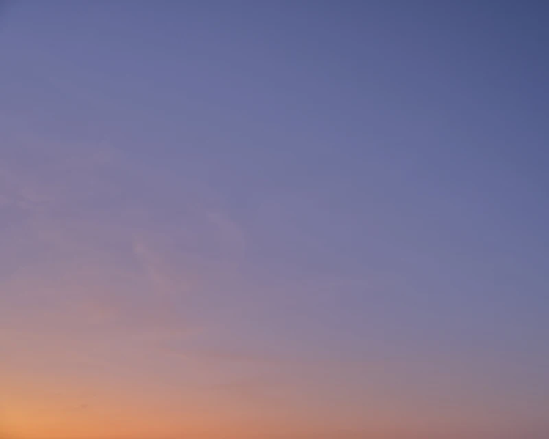 Gradient sky with soft pastel hues of blue, purple, and orange blending seamlessly, creating a serene and tranquil atmosphere.