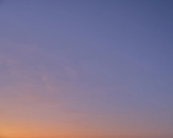 Gradient sky with soft pastel hues of blue, purple, and orange blending seamlessly, creating a serene and tranquil atmosphere.