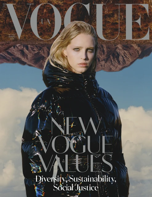 Vogue magazine cover featuring a fair-skinned blonde woman in a black puffer jacket, against a blue sky and mountain backdrop.