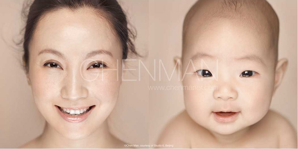 Close-up portrait of a smiling adult woman next to a smiling infant against a neutral background, with a signature watermark visible in the center.